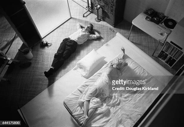 Douglas laying next to Marilyn Monroe after photographing her in Hollywood, CA - November 1961