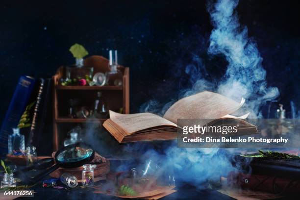 flying magical book with smoke - horror story stock pictures, royalty-free photos & images