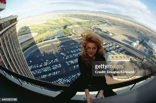 Entertainer Ann-Margret sits on the railing of a hotel balcony in Las Vegas.