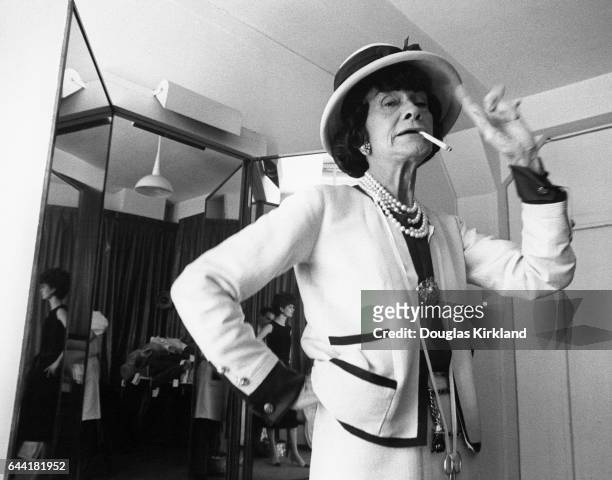 Coco Chanel smoking cigarette in dressing room.