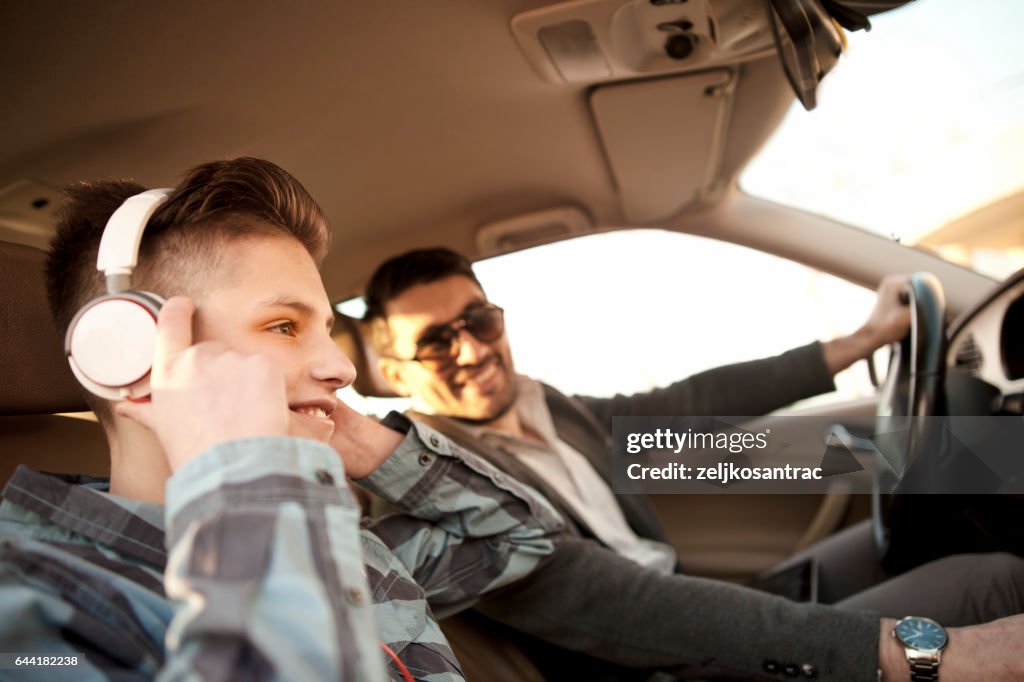 Father and son driving in car