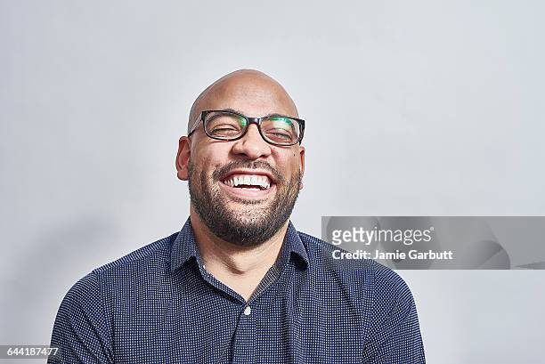 mixed race male laughing with his head back - parte di una serie foto e immagini stock