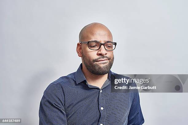 a british mixed race male looking concerned - twijfel stockfoto's en -beelden