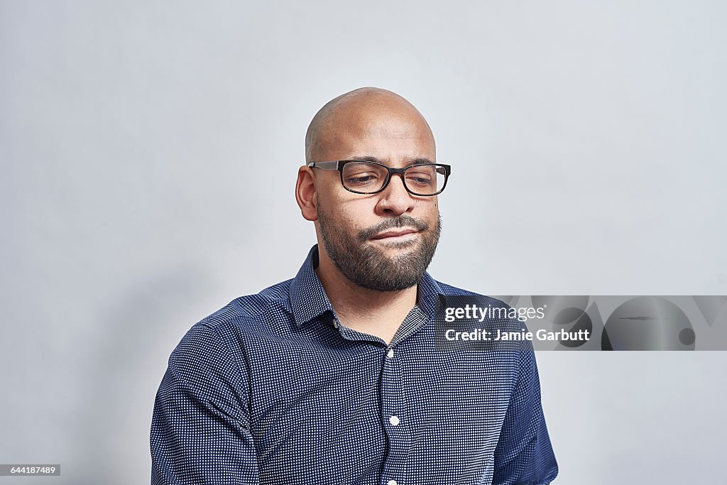 A British mixed race male looking concerned