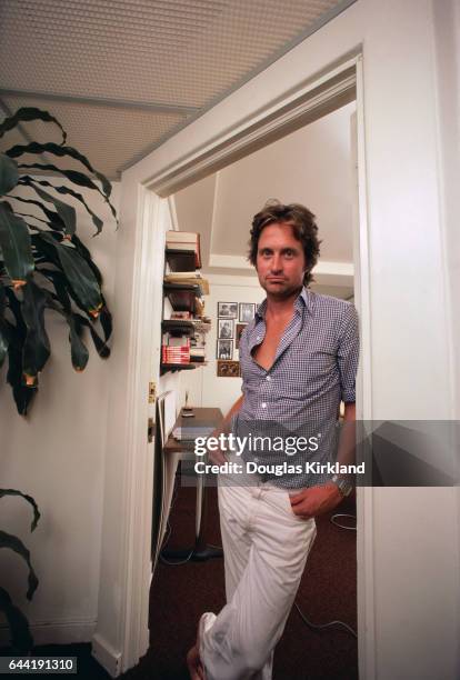 Michael Douglas stands in a doorway inside his home.