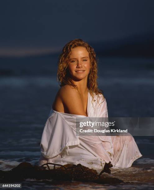 Actress Amanda Peterson Sitting on a Beach