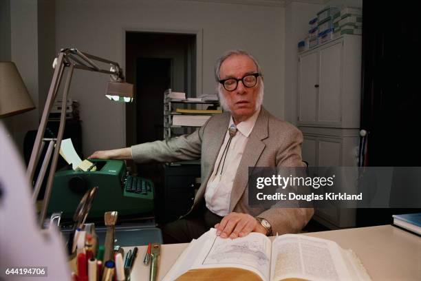 Author and Scientist Isaac Asimov Looking at a Reference Book