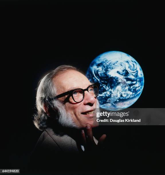 Noted science fiction author Isaac Asimov with a photo of the Earth from space.