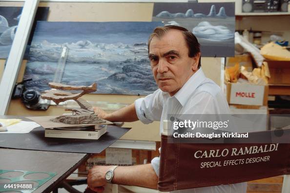 Special effects specialist Carlo Rambaldi of Rizzoli sits by a model ...