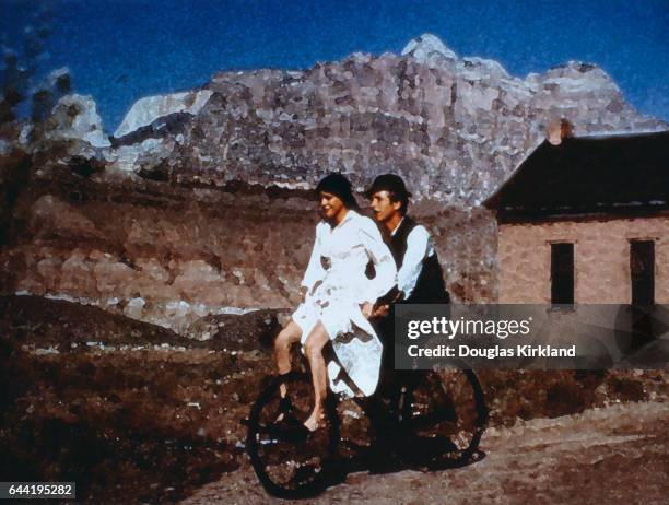 Paul Newman and Katherine Ross riding a bicycle in a computer altered still from Butch Cassidy and the Sundance Kid.