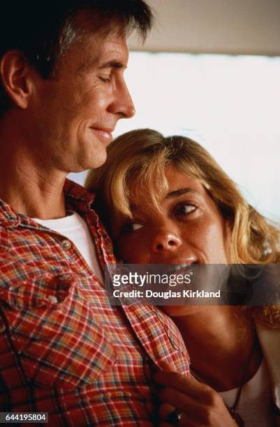 Actor Anthony Perkins, who is best known for his role as Norman Bates in the 1960 Alfred Hitchcock thriller Psycho, sits with his wife, Berry...