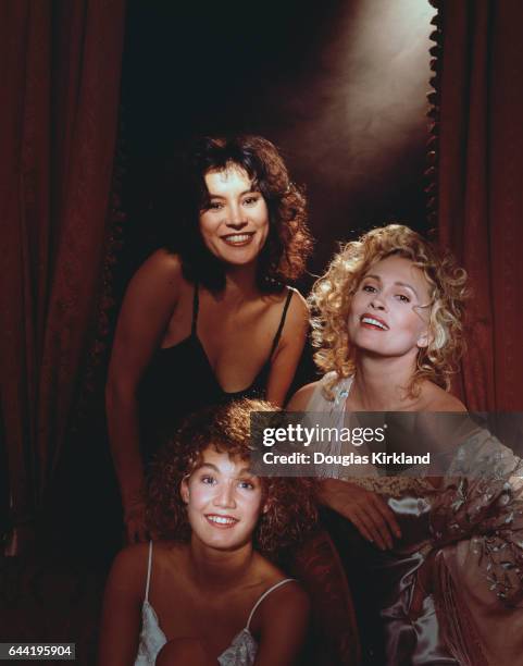 Actresses Jennifer Tilly, Faye Dunaway, and Emily Lloyd pose in lingerie during a photo shoot for their upcoming film Scorchers.