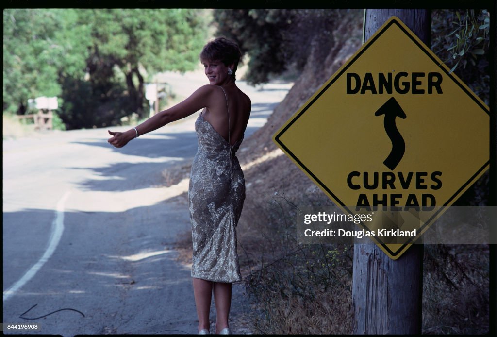 Jamie Lee Curtis Hitchhiking in Cocktail Dress