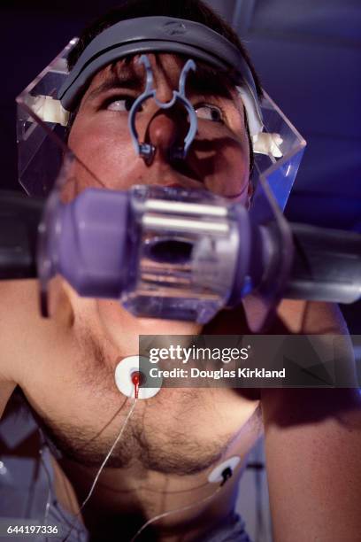 Young man tests himself using a device which measures his oxygen efficiency at the United States Olympic Sports Complex. He is training for the 1984...