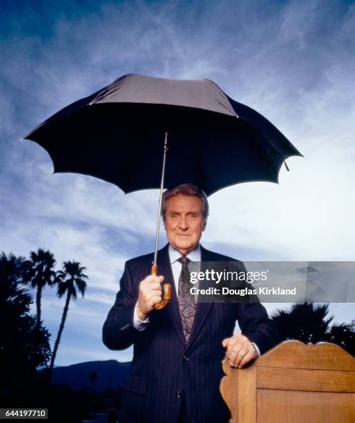 Actor Patrick Macnee Holding an Umbrella