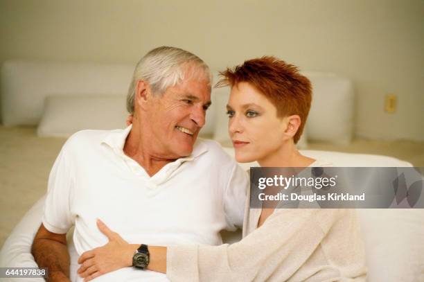 Timothy Leary sits on a bed with his wife, Barbara Chase.