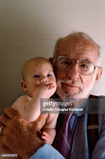 American pediatrician Dr. Benjamin Spock holds an infant. Dr. Spock became well known through is revolutionary work and writing on children and child...