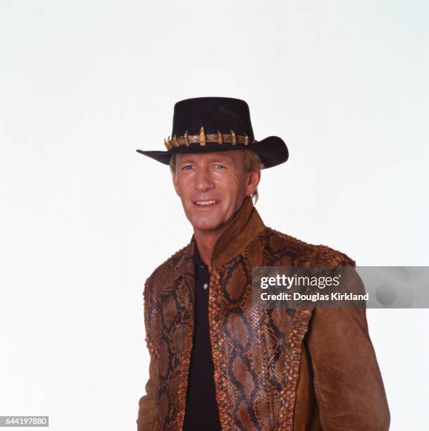 Australian actor Paul Hogan wears his Crocodile Dundee vest and hat.