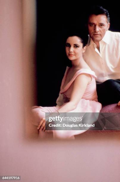 Elizabeth Taylor and Richard Burton are reflected in a mirror.