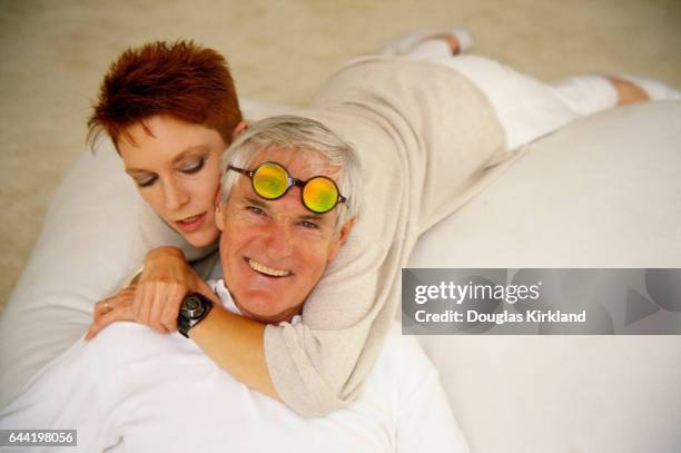 Timothy Leary lies on a bed with his wife, actress Barbara Chase.