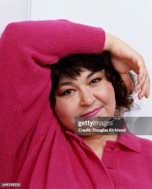 American comedian Roseanne Barr poses with her arm on her head.