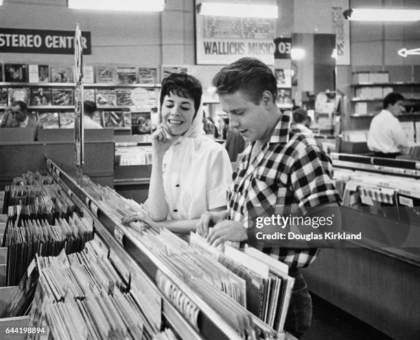 Rockabilly singer Eddie Cochran and his fiancee, songwriter Sharon Sheeley, shop for records in a Los Angeles music store in the late 1950s.