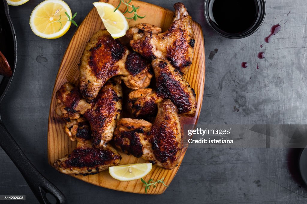 Roast chicken wings on cutting board