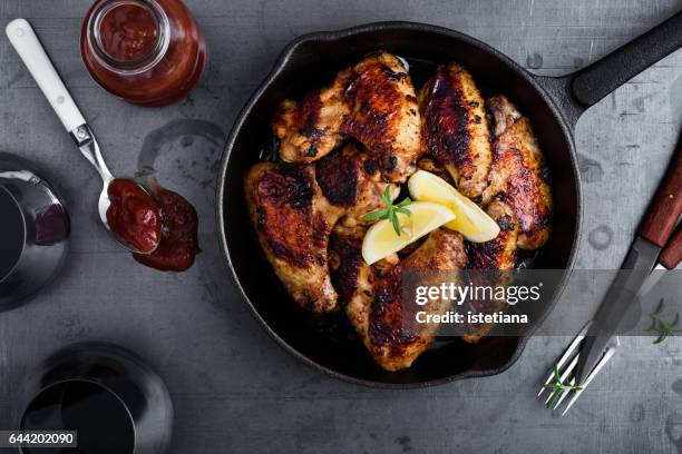roast chicken wings in cast iron pan - cast iron stock pictures, royalty-free photos & images