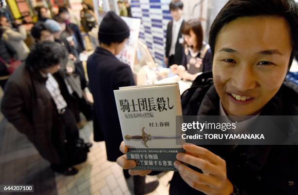 Fan of Haruki Murakami, the Japanese author perennially pegged as a contender for the Nobel literature prize, holds his new novel at a bookstore in...