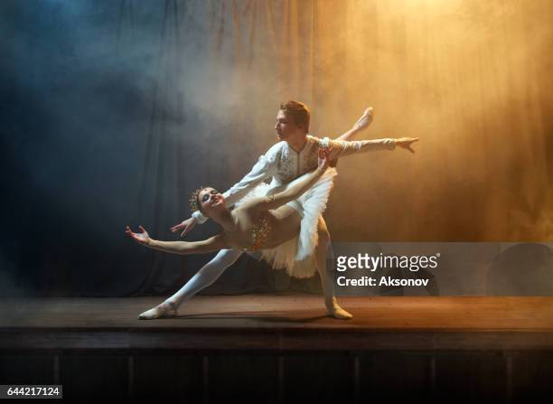 ballet dancers performing on stage in theatre - ballet stage stock pictures, royalty-free photos & images