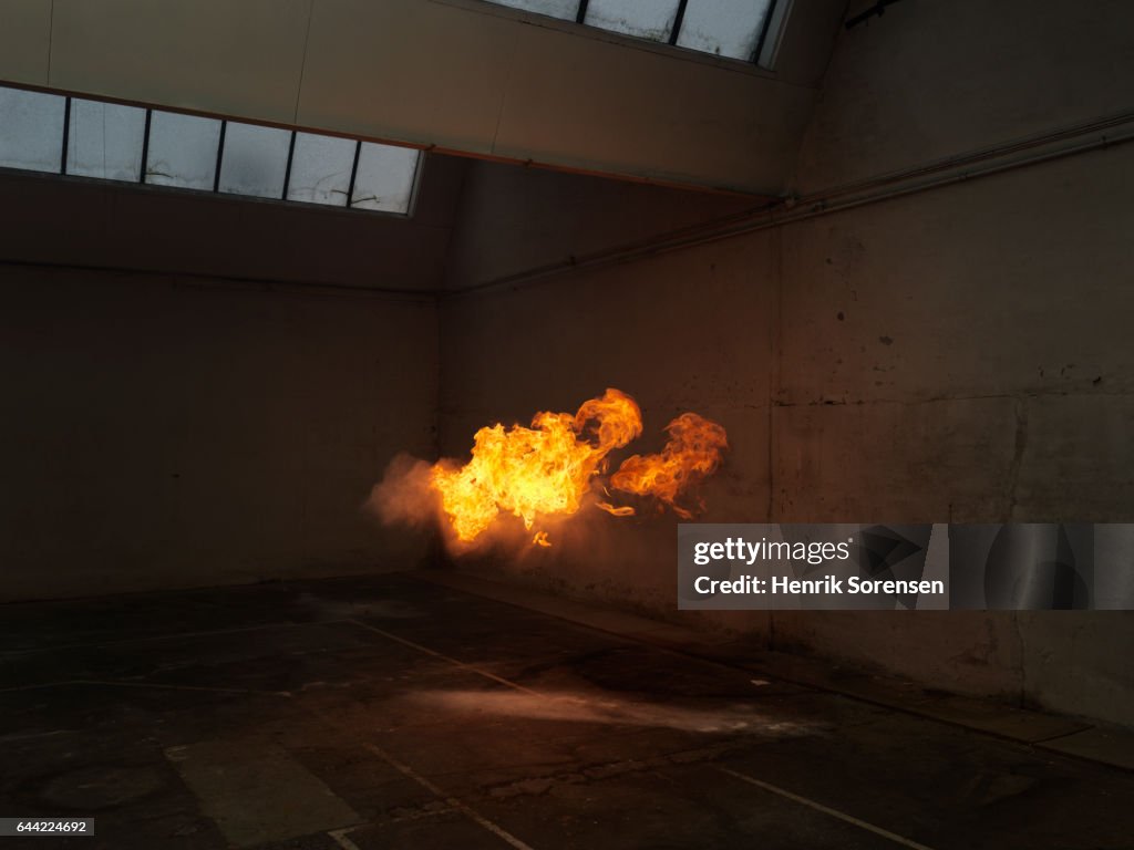Subtle flame inside old warehouse