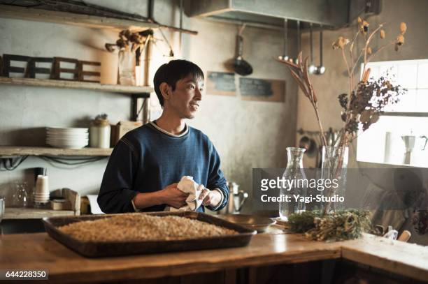 male cafe owner preparing coffee in coffee shop - only japanese stock pictures, royalty-free photos & images
