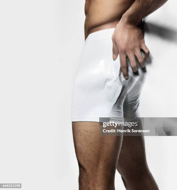 man with pain in his buttock - male buttocks stockfoto's en -beelden