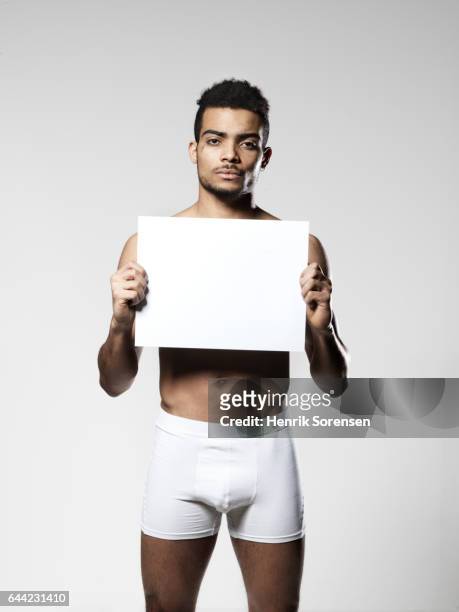 man holding up blank piece of paper - white shorts stock pictures, royalty-free photos & images