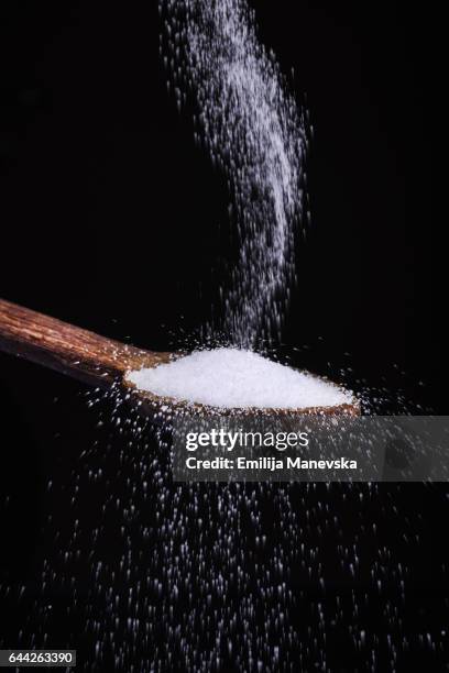 salt falling in wooden spoon - salt shaker stock pictures, royalty-free photos & images