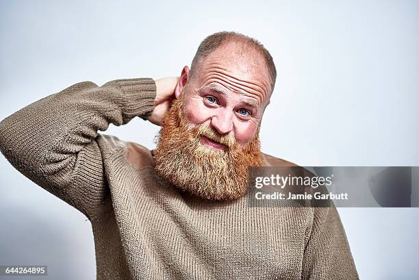 british male with a large beard looking awkward - rosy cheeks stock pictures, royalty-free photos & images