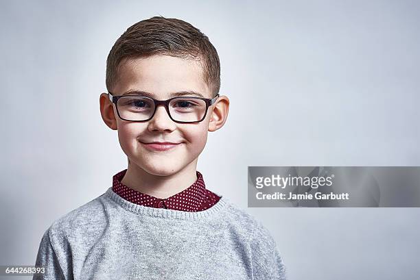 a british child stood smiling proudly - boy brown hair stock pictures, royalty-free photos & images