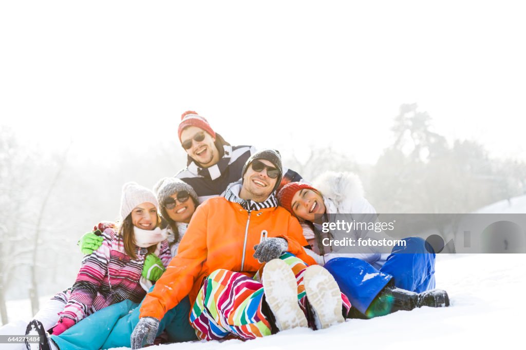Portrait of happy young friends in snow