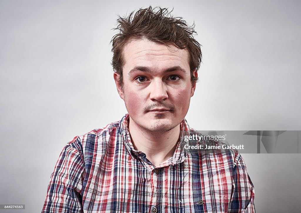 A mid 20's British male with a serious expression