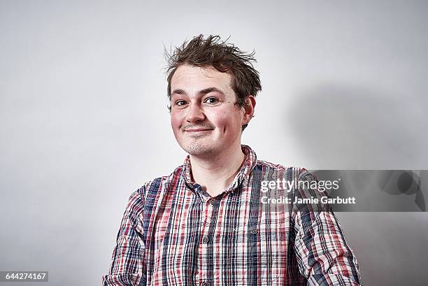 a mid 20's british male with a cheeky expression - trouble maker studios stock pictures, royalty-free photos & images