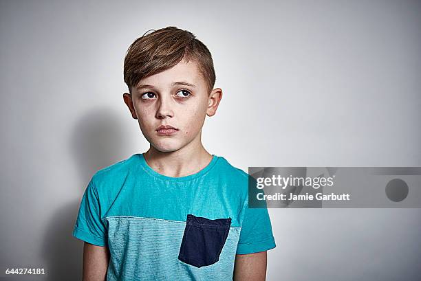 british male child looking concerned and worried - boy sad foto e immagini stock