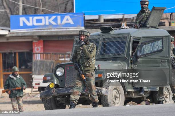 Army soldiers stand guard on Srinagar-Jammu National Highway at Lethapora on February 23, 2017 some 30 kms, south of Srinagar, India. Three army...