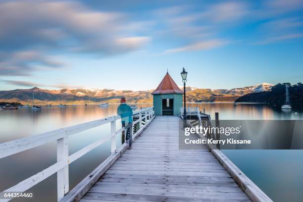 long exposure on akaroa wharf - akaroa stock pictures, royalty-free photos & images