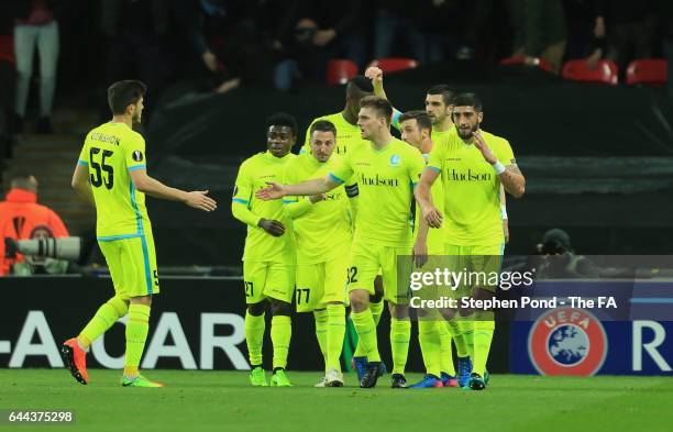 Gent players celebrate as Harry Kane of Tottenham Hotspur scores an own goal for their first during the UEFA Europa League Round of 32 second leg...