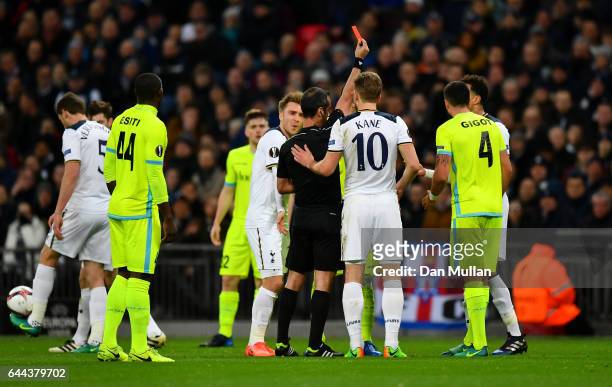 Referee Manuel De Sousa shows a red card to Dele Alli of Tottenham Hotspur as he is sent off during the UEFA Europa League Round of 32 second leg...