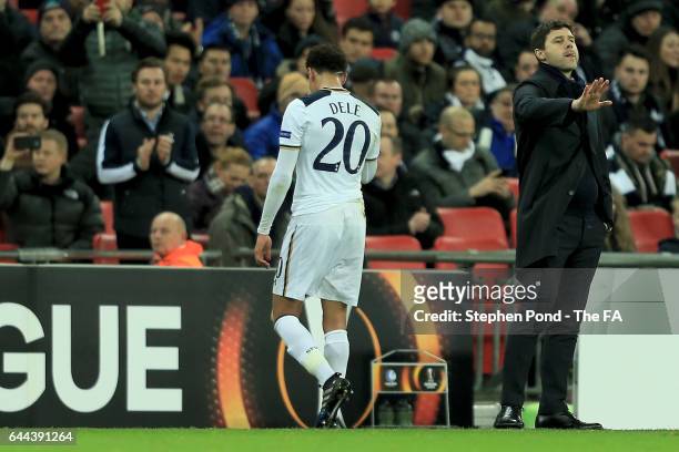 Dele Alli of Tottenham Hotspur walks past Mauricio Pochettino manager of Tottenham Hotspur as he is sent off during the UEFA Europa League Round of...