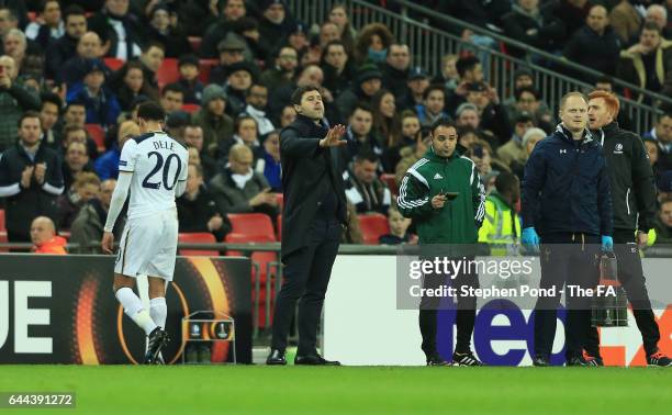 Dele Alli of Tottenham Hotspur walks past Mauricio Pochettino manager of Tottenham Hotspur as he is sent off during the UEFA Europa League Round of...