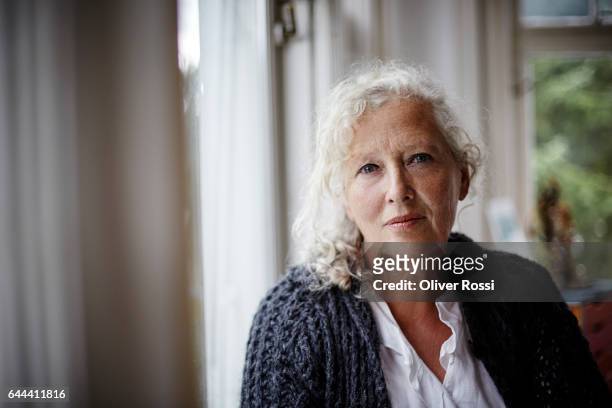 portrait of senior woman at home - 60 64 years stock pictures, royalty-free photos & images