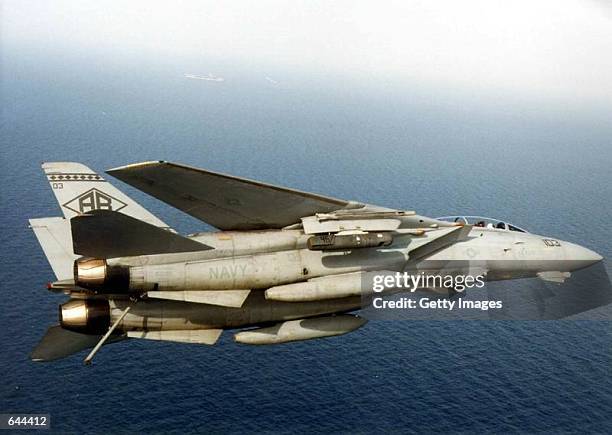 An F-14 Tomcat equipped with a Low-Altitude Navigation and Targeting Infrared for Night pod begins a flight pattern January 24, 2000 in preparation...