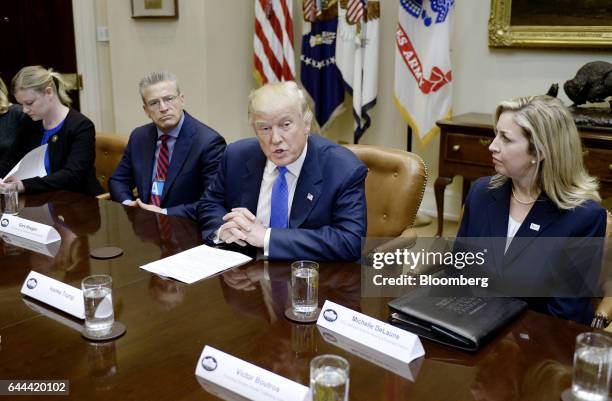 President Donald Trump speaks while Gary Haugen, chief executive officer and founder of the International Justice Mission, left, and Michelle...